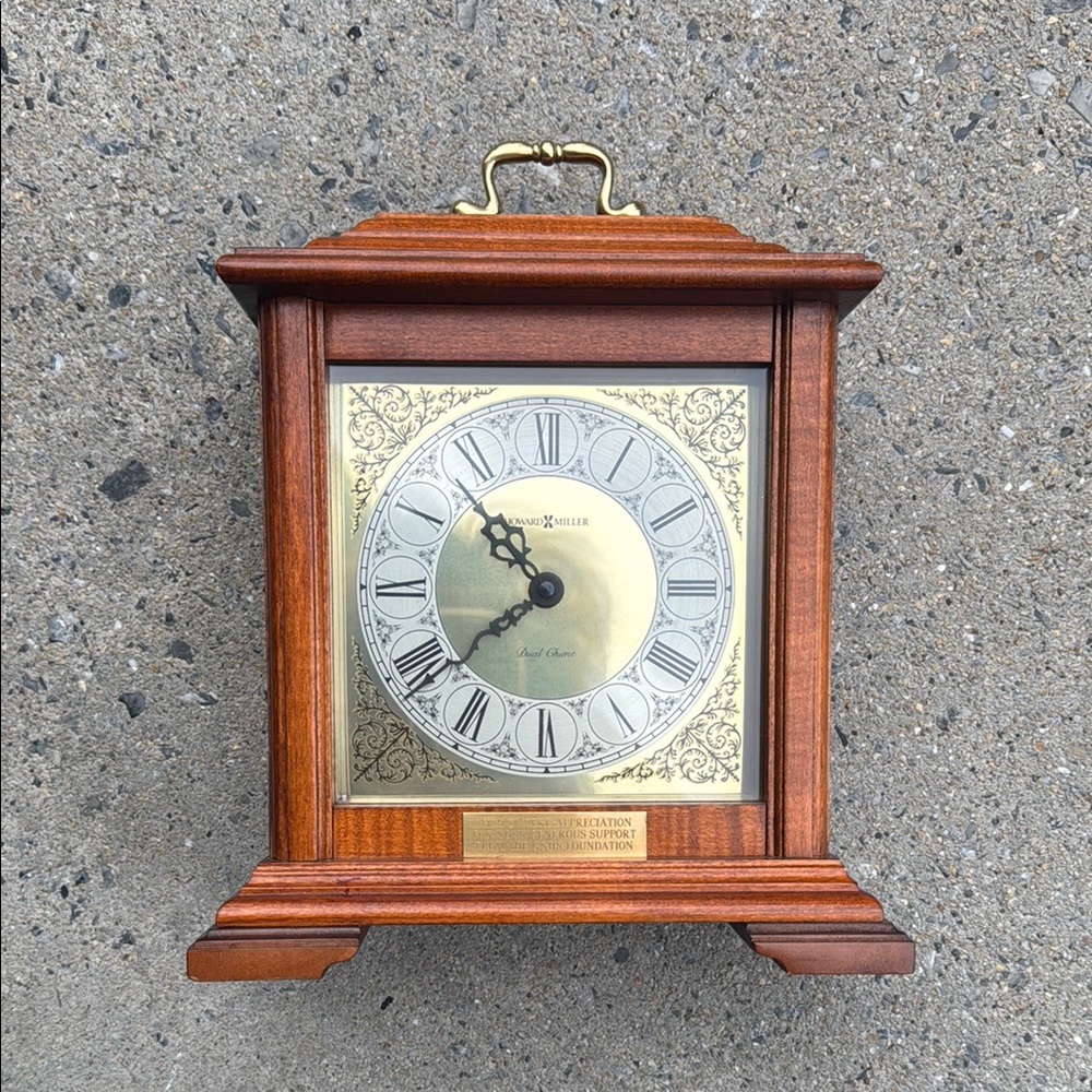 Howard Miller, mantle clock, cherry, wood, and gold chime clock Roman Numerals